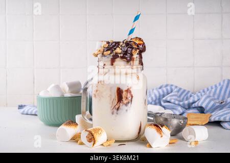 Tasty overloaded S`mores winter milkshake, crazy shake with ice cream, smores  roasted marshmallow, chocolate and graham cracker crumbs Stock Photo